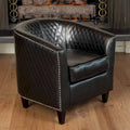 Fauteuil club en cuir reconstitué matelassé, clous décoratifs, coussin amovible, pieds en bois foncé